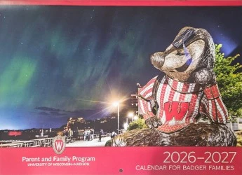 The image features a "2026-2027 Calendar for Badger Families" with a statue of a badger in a sweater under a night sky with northern lights, from the Parent and Family Program at the University of Wisconsin-Madison.